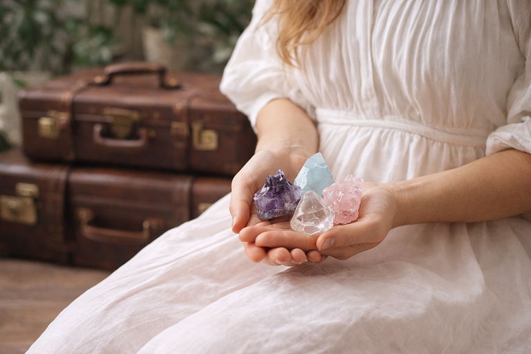 woman holding crystals for travel ritual