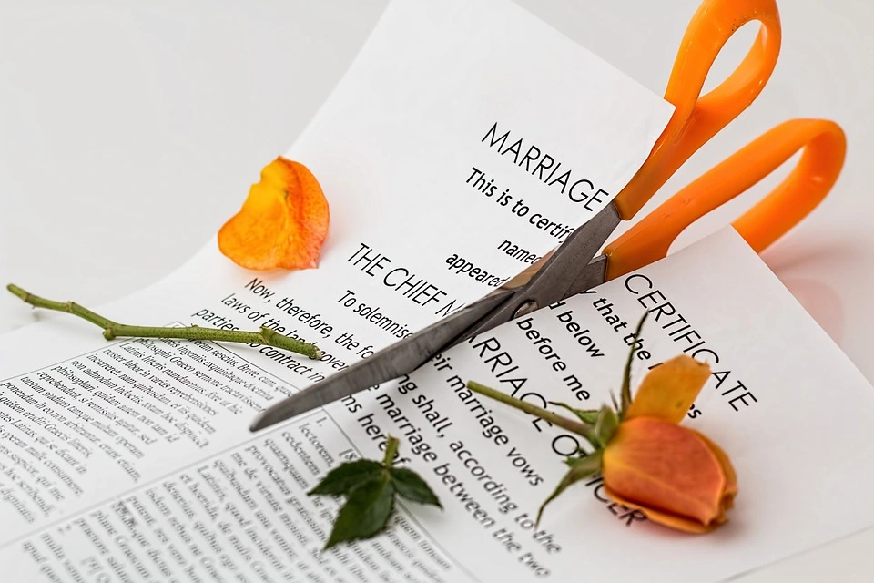 divorce spell - scissors cutting through marriage certificate