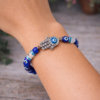 Evil Eye Quartz Bracelet with Hamsa Hand on hand