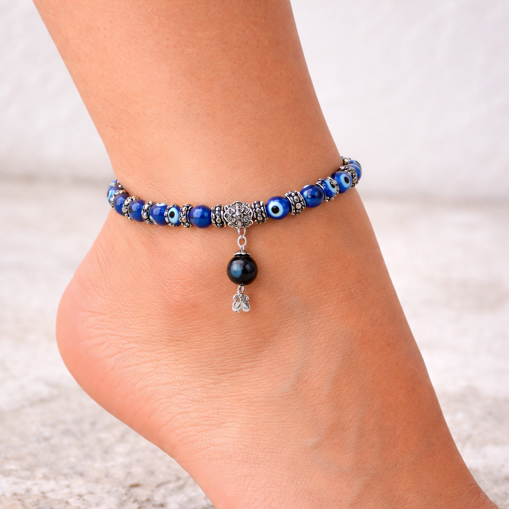 close up of a woman wearing anklet with evil eye protection